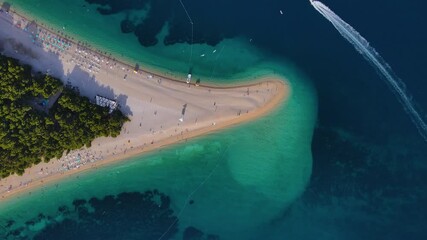 Wall Mural - Aerial view of the Zlatni Rat sandy beach and sailing boat in Adriatic sea on Brac island, Croatia. 4k drone video. Top view. Summer vacation resort