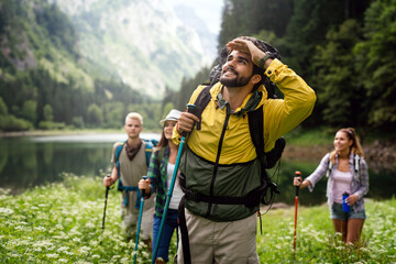 Wall Mural - Group of young friends hiking in countryside. Multiracial happy people travelling