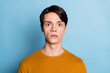 Photo of young guy unhappy sad upset scared fear horror fail problem isolated over blue color background