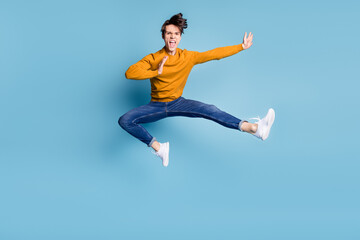 Poster - Full body photo of impressed brunet millennial guy fight wear sweater jeans isolated on blue color background