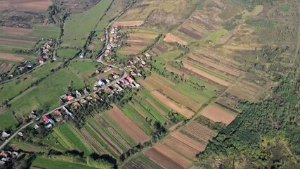 Wall Mural - Top view or aerial of fresh green fields and village view before harvest at summer