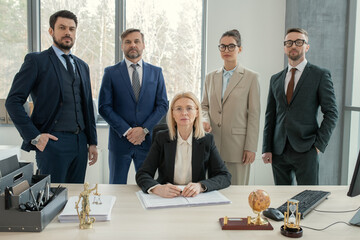 Poster - Portrait of successful business team with their leader looking at camera while working in team at office