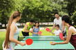 © New Africa - Happy families playing ping pong in park
