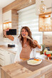 Woman having fun while cooking lunch in the kitchen