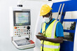 © godji10 - African American technician use tablet to control cutting machines