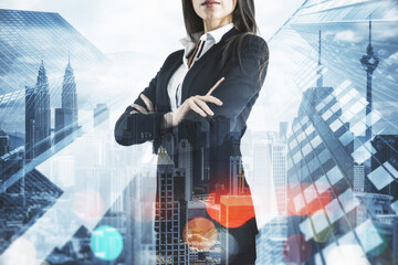 Wall Mural - Businesswoman with folded arms standing on abstract city background. Success and work concept. Double exposure.