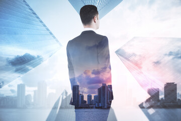 Poster - Back view of young businessman standing on abstract city background with mock up place. Success and tomorrow concept. Double exposure.