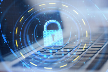 Leinwandbilder - Close up of laptop with glowing padlock hologram on blurry desktop background. Online safety and protection concept. Double exposure.