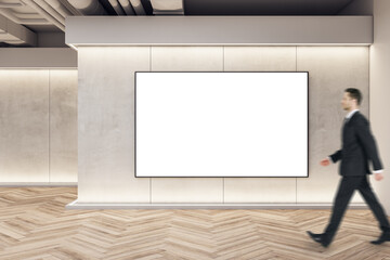 Sticker - Businessman walking in modern exhibition space concrete interior with empty banner on wall and wooden flooring. Mock up.