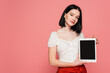 © LIGHTFIELD STUDIOS - Pretty woman with vitiligo holding digital tablet with blank screen isolated on pink