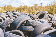 Dump Of Used Automobile Tires. Poisonous Fumes Into Atmosphere, Environmental Pollution And Problem Of Waste Recycling Concept