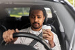 © Syda Productions - transport, vehicle and people concept - indian man or driver with takeaway coffee cup driving car