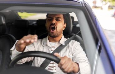 Wall Mural - transport, vehicle and people concept - angry indian man or driver driving car