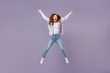 © ViDi Studio - Full size body length laughing young redhead curly green-eyed woman 20s wears white T-shirt violet jacket jump spreading hands and legs isolated on pastel purple color wall background studio portrait.