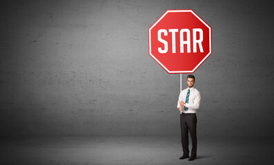 Young business person holding road sign