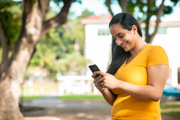 young latin woman checking the phone