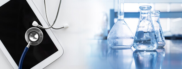 Wall Mural - clear water in flask with stethoscope and computer tablet medical science lab banner background