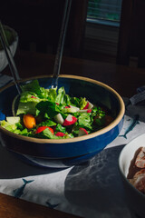 Sticker - lettuce salad with tomato, radish in blue bowl 