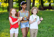 © Evgeniy Kalinovskiy - a group of children of athletes of different nationalities with medals around their necks against the background of a park and greenery.