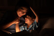 © chokniti - asian parent bedtime with kid, mom playing with child, Mother and daughter enjoying on the bed, happy, smiling to each other, family quality time concept .