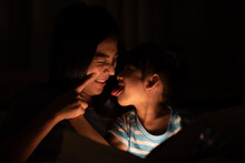 Asian Parent Bedtime With Kid, Mom Playing With Child, Mother And Daughter Enjoying On The Bed, Happy, Smiling To Each Other, Family Quality Time Concept .