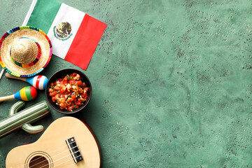 Bowl of tasty salsa sauce with symbols of Mexico on color background