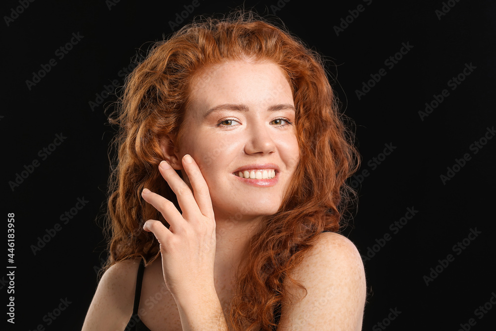 Beautiful redhead woman on dark background