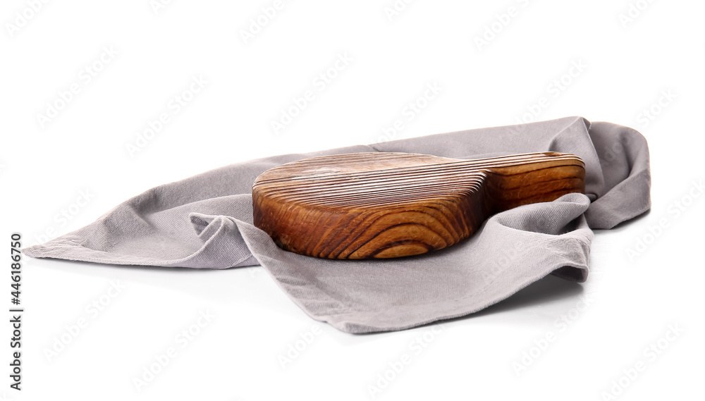 Fabric napkin and wooden board on white background