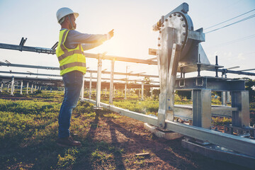 engineer inspect solar tracking machine in solar power plant; Monitor project of  automatic solar tracking