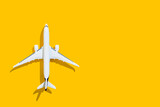Fototapeta Boho - Airplane on a yellow background. Travel and flights.