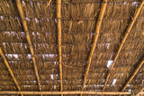 Fototapeta  - Old dry grass roof with bamboo beam structure