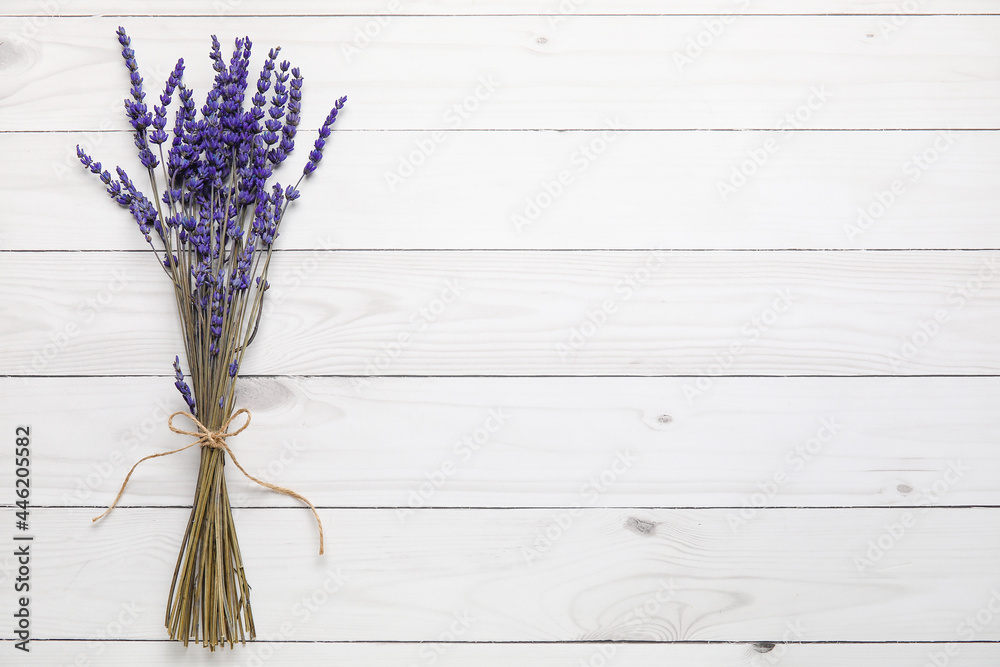 Beautiful lavender flowers on light wooden background