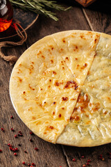 Wall Mural - Caucasian flat bread khychin with cheese and greens filling