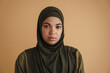 Black muslim woman in hijab posing while looking at camera