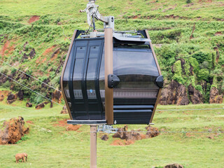 Ropeway cabin with the beautiful green landscape in the background in Cantabria, Spain