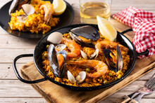 Traditional Spanish Seafood Paella On Wooden Table