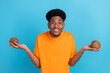 © deagreez - Photo of cheerful young afro american happy man hold hands coconut food isolated on blue color background