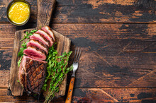 Sliced Grilled Duck Meat Breast Fillet Steak. Dark Wooden Background. Top View. Copy Space