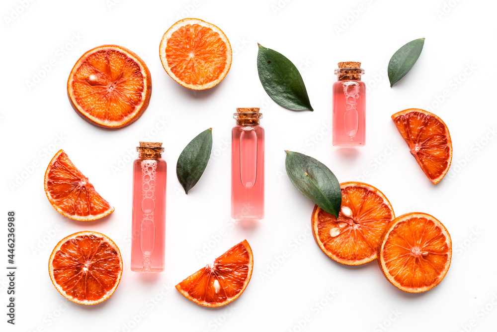 Grapefruit fragrance essential oil in bottles with fresh fruits. Top view - obrazy, fototapety, plakaty 