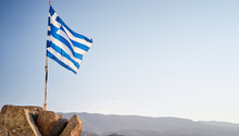 National Flag Of Greece Waving Against Blue Sky.