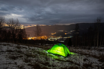 Wall Mural - tent in the winter in the mountains with a view of the night city
