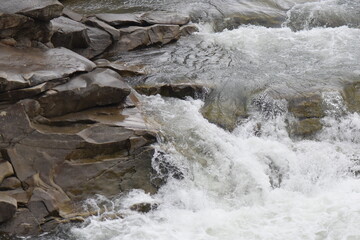 Wall Mural - water flowing over rocks