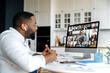 © Kateryna - Online video communication. African American business man has a virtual meeting with multiracial business partners, discussing financial strategy, talking on a video call, group brainstorming