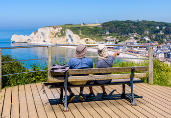 A couple enjoying the view over Etretat coast in Normandy, France