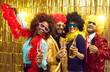 © Studio Romantic - Funny team, disco party, holidays concept. Diverse multiracial group of four friends in color curly hair wig and bra laughing sharing good and positive mood drinking champagne celebrating weekend