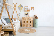 Stylish Baby Room With Toys, Wooden Bed And Mock Up Poster Frame. Cute Home Decor. Scandinavian Interior Of A Children's Room.