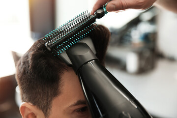 Wall Mural - Professional barber making stylish haircut in salon, closeup