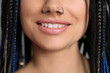 Young woman with nose piercing and dreadlocks, closeup