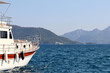 White boat Aegean sea bay on background of mountain islands and yachts in mist. Water travel, summer vacation