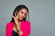 Fashion Portrait Black Woman in Pink stylish jacket. Pink Makeup curly hair and braids. luxury Fashion model African American posing in studio against a pink wall. Beautiful black woman  